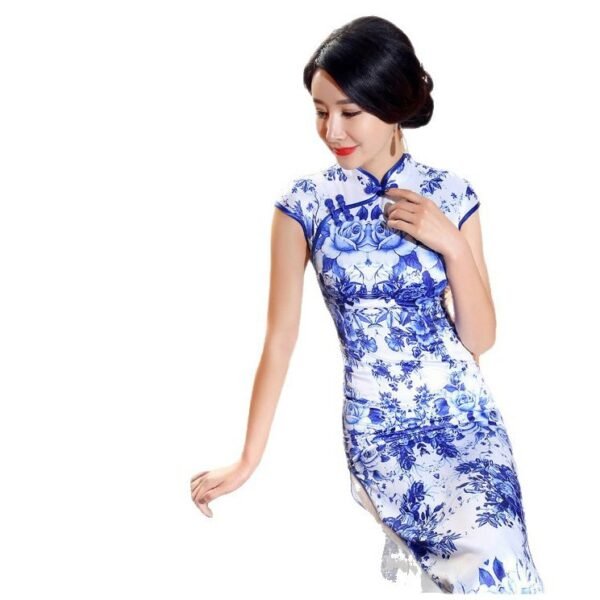 Woman wearing floor-length blue-and-white porcelain floral qipao in traditional setting